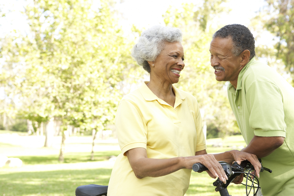 smiling man and woman with bicycles